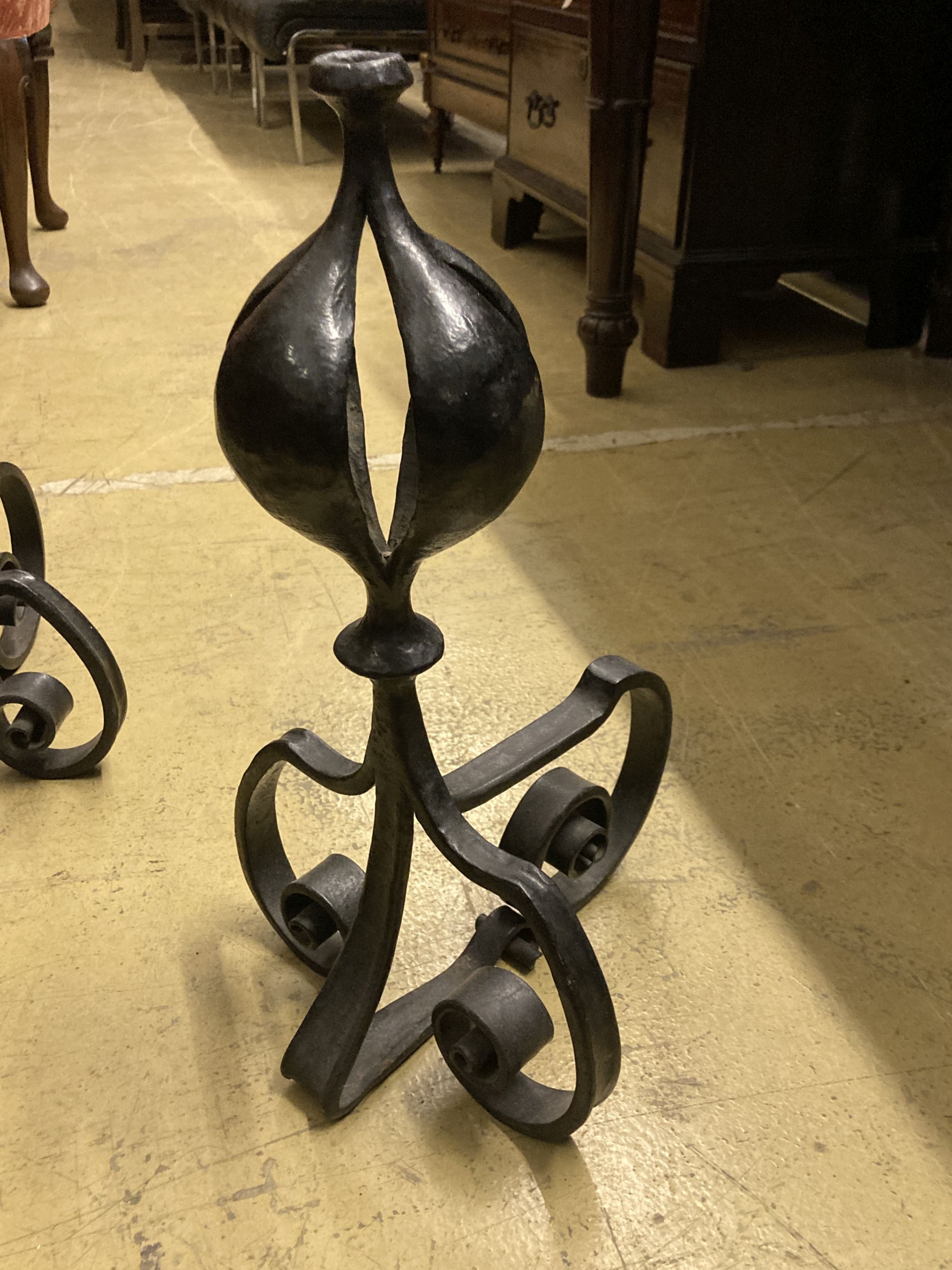 A George III pierced steel serpentine fender, length 130cm, together with a pair of wrought iron firedogs